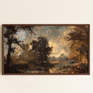May include: A rectangular landscape painting in a dark wood frame depicting a river scene with dark silhouettes of trees against a cloudy, golden-toned sky. The artwork features deep brown, black, and muted yellow tones with visible brushstrokes.
