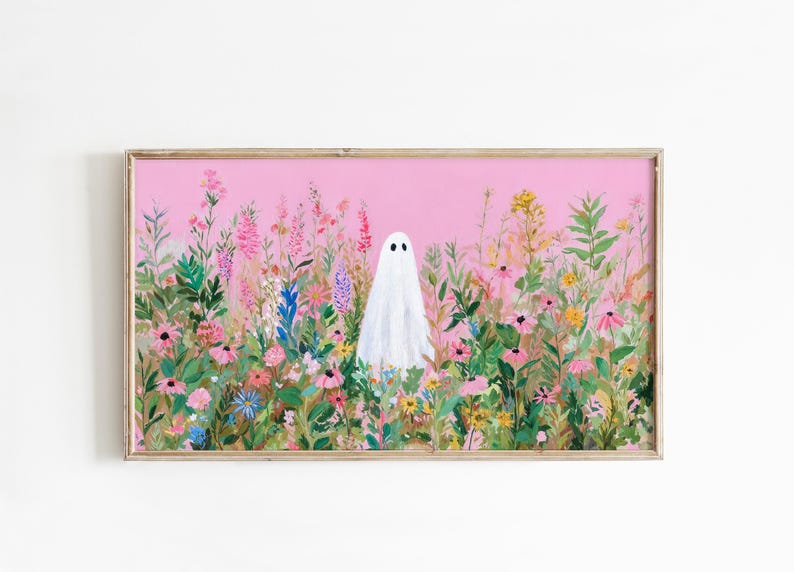 May include: A framed art print featuring a white ghost figure standing in a field of colorful wildflowers. The background is a solid pink color. The artwork is in a wooden frame.