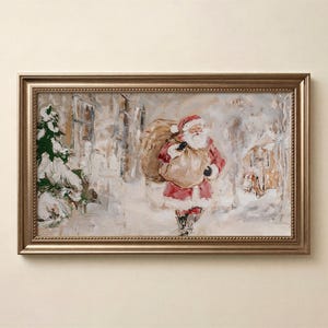 May include: A rectangular framed painting depicting a figure of Santa Claus in a red suit carrying a large tan sack over a shoulder. The scene is set in a snowy outdoor environment with a green pine tree and muted building structures in the background.