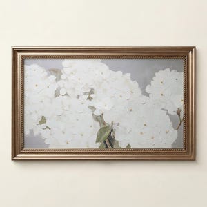 May include: A rectangular wall art piece featuring a textured oil painting of white hydrangea flowers against a soft gray background, enclosed in a metallic bronze-toned frame with a beaded inner edge detail and a smooth outer border finish.