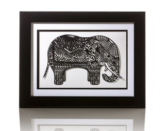 May include: A black and white paper cut art piece of an elephant framed in a black frame. The elephant is intricately detailed with a patterned design.