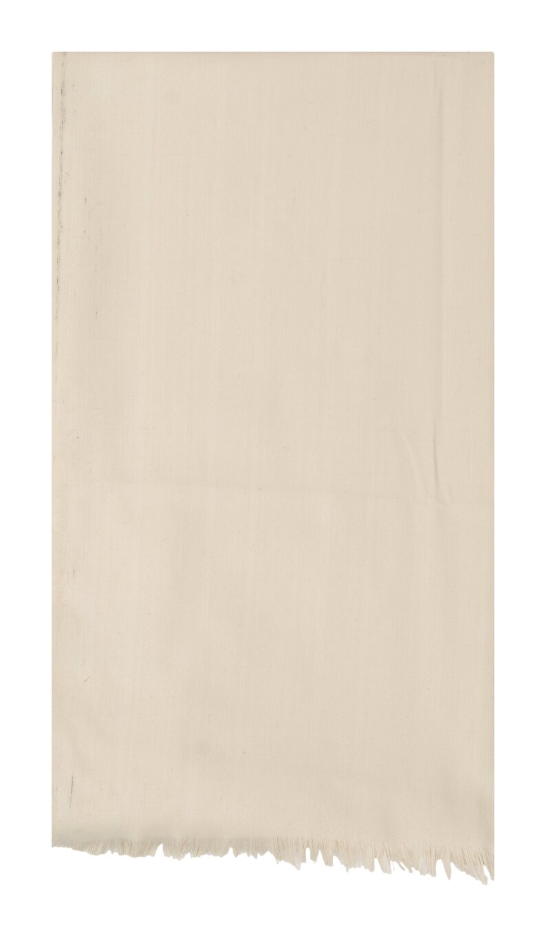 May include: A plain off-white cotton scarf with a frayed edge.