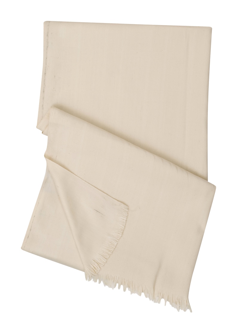 May include: A cream-colored woven shawl with a fringed edge.