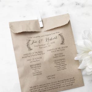 May include: A brown paper bag wedding program held closed with a white clip. The program includes the names of the bride and groom, wedding date, location, wedding party, and a message to guests.