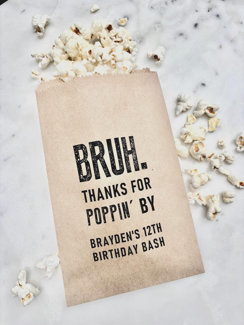 May include: A brown paper bag filled with popcorn, with some popcorn spilling out. The bag has the text "BRUH. THANKS FOR POPPIN' BY BRAYDEN'S 12TH BIRTHDAY BASH" printed in black.