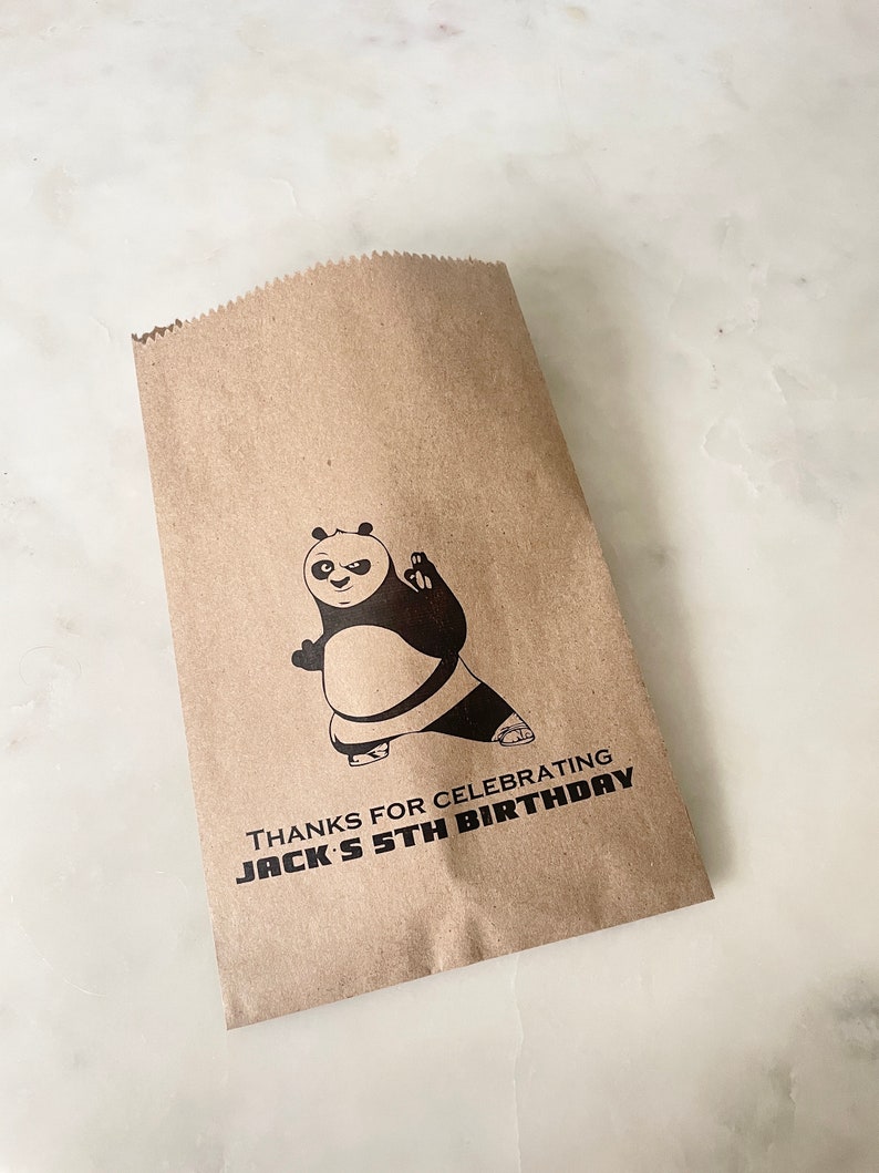 May include: Brown paper bag with a black and white panda bear illustration. The bag has the text "Thanks for celebrating Jack's 5th Birthday" printed on it.