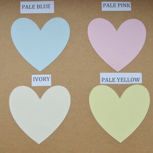 Puede incluir: Cuatro muestras de papel en forma de coraz&oacute;n en azul p&aacute;lido, rosa p&aacute;lido, marfil y amarillo p&aacute;lido. Los colores est&aacute;n etiquetados como "Pale Blue", "Pale Pink", "Ivory" y "Pale Yellow".