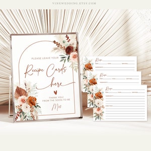 May include: A printable sign with a floral design and the text "Please leave your Recipe Cards here. Thank you! From the soon-to-be Mrs."  Three blank recipe cards with lines for ingredients, directions, prep time, cook time, and servings.