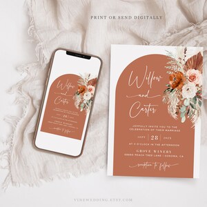 May include: A wedding invitation and a smartphone showing the same design. The invitation has an arch design with floral accents and the names "Willow and Carter." The invitation includes event details.