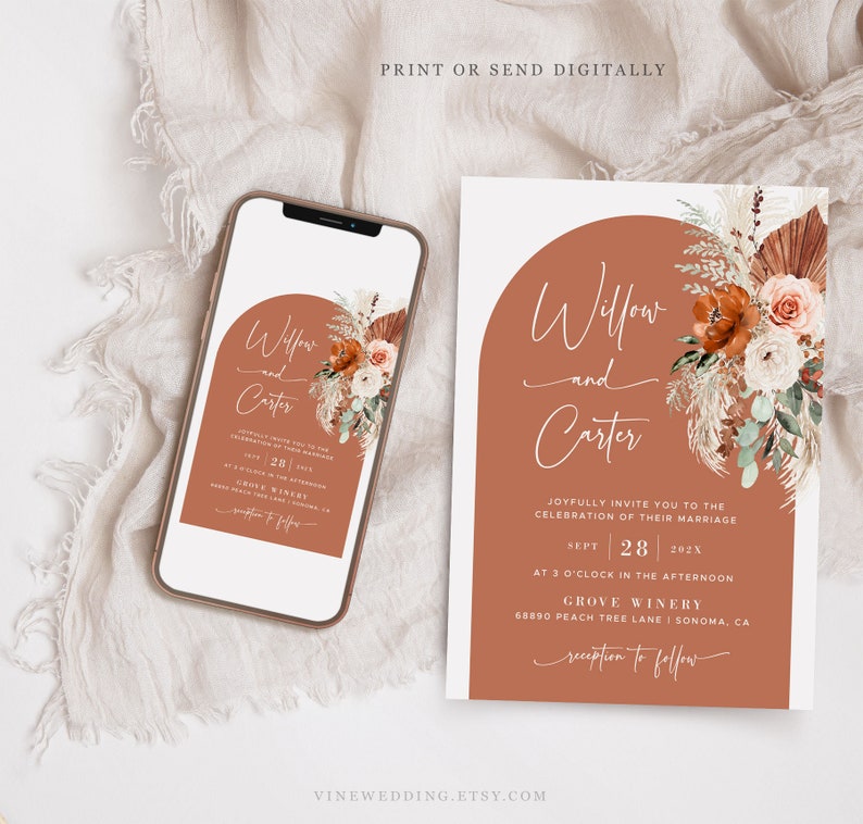 May include: A wedding invitation and a smartphone showing the same design. The invitation has an arch design with floral accents and the names "Willow and Carter." The invitation includes event details.