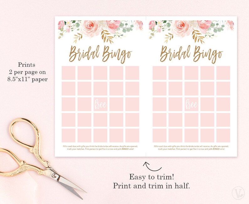 May include: Two pink and white Bridal Bingo game sheets with floral accents and gold text. The text reads "Bridal Bingo" and "free" in the center. The sheets are designed to print two per 8.5" x 11" paper. Scissors are in the lower left corner.