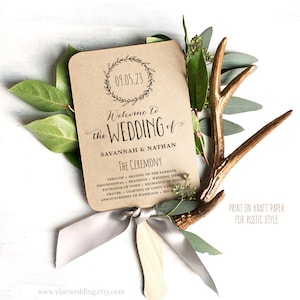 May include: A brown paper wedding program fan with a rustic design. The fan features a wreath with the date 09.05.23 and the text "Welcome to the Wedding of Savannah & Nathan." The program lists the ceremony order, including the prelude, seating of the parents, processional, readings, wedding message, exchange of vows, exchange of rings, prayer, lighting of unity candle, announcement of marriage, and reception. The text "Print on Kraft Paper for Rustic Style" is printed at the bottom of the fan.