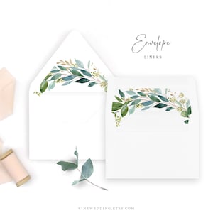 May include: White envelope liners with watercolor greenery design. The liners feature a delicate arrangement of green leaves and gold accents. The text "Envelope Liners" is written in a script font. The website address is also visible.