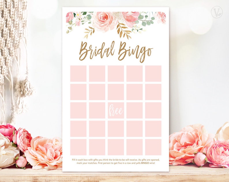 May include: A Bridal Bingo game card with a floral design. The top of the card features pink and gold flowers. The words "Bridal Bingo" are in gold script. The card has pink squares for game play and the word "free".