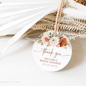 May include: Round, white thank you tag with a floral design in shades of peach, white, and orange. The text reads "Thank you, Willow's Bridal Shower, 09.28.20XX".