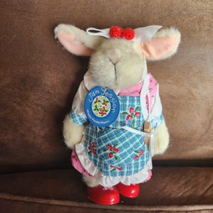 May include: A handmade, wooden serving tray with a natural finish. The tray features a rectangular shape with rounded corners and two carved handles. The wood grain is visible, adding to its rustic charm. Perfect for serving food or displaying items.