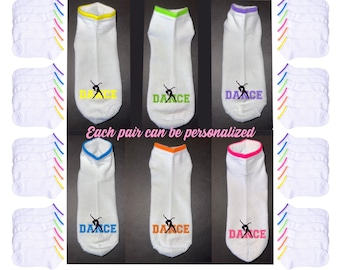 May include: A set of 12 pairs of white ankle socks with colorful trim. Each sock has a dancer silhouette and the word "DANCE" embroidered on the front. The socks are available in a variety of colors, including yellow, green, purple, blue, orange, and pink.