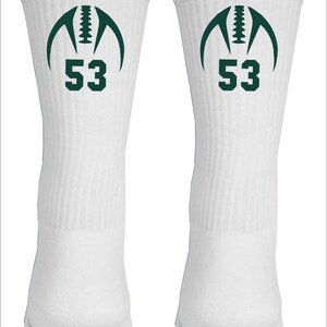 May include: White athletic socks with a green football graphic and the number 53 on the front.