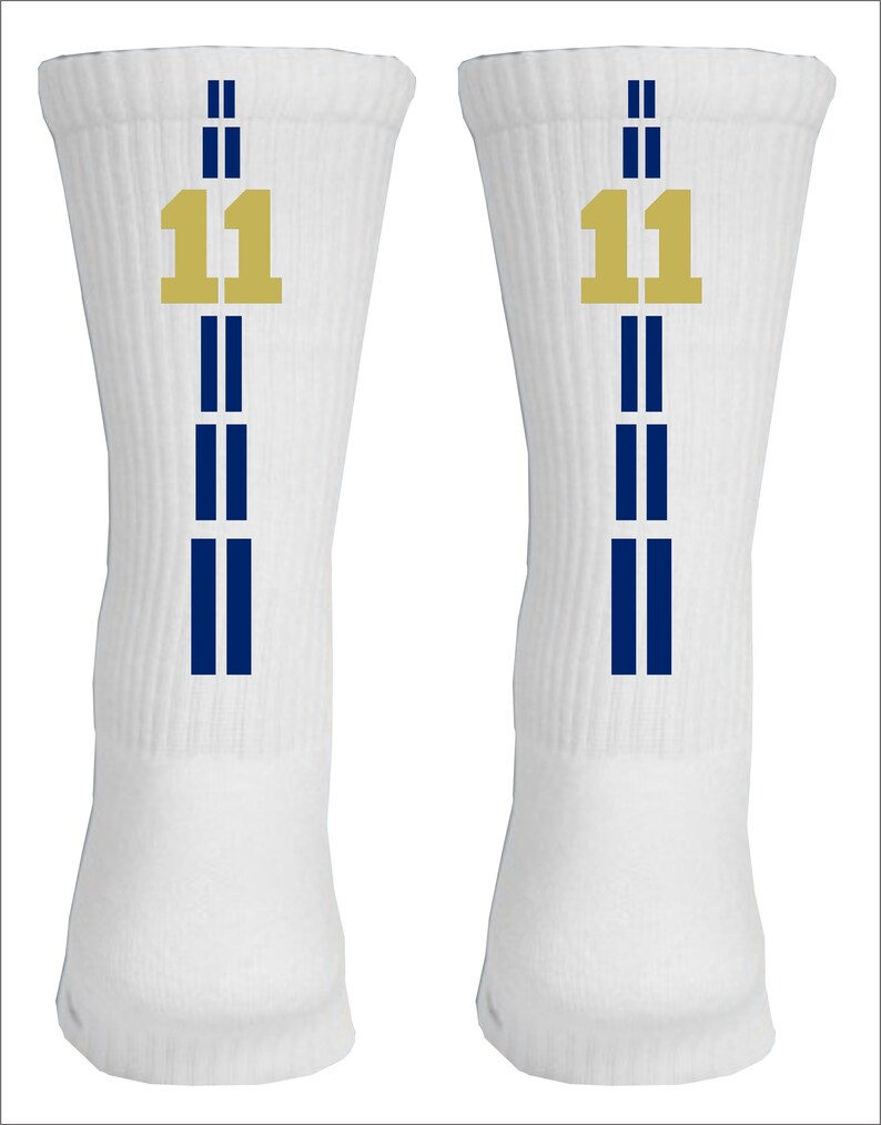 May include: A pair of white athletic socks with blue stripes and a gold number 11 on each sock.