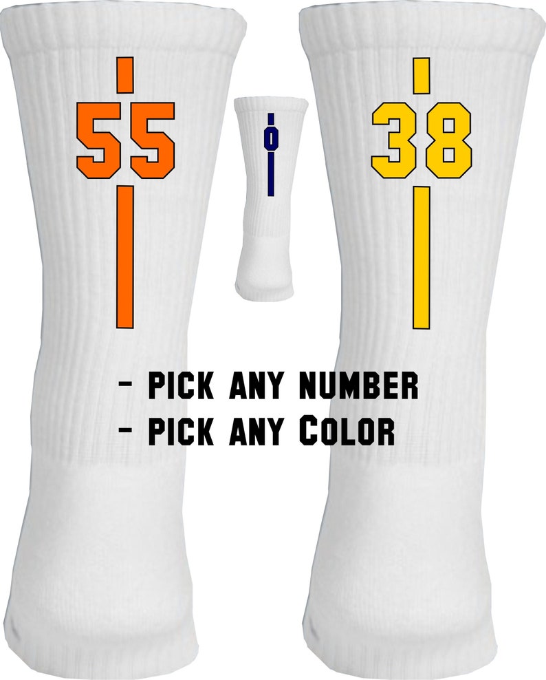 May include: Two white athletic socks with a vertical stripe and a number on each sock. The sock on the left has an orange stripe and the number 55. The sock on the right has a yellow stripe and the number 38. The text "PICK ANY NUMBER" and "PICK ANY COLOR" is below the socks.