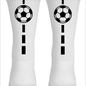 May include: Pair of white athletic socks with a black soccer ball and a dashed line design.