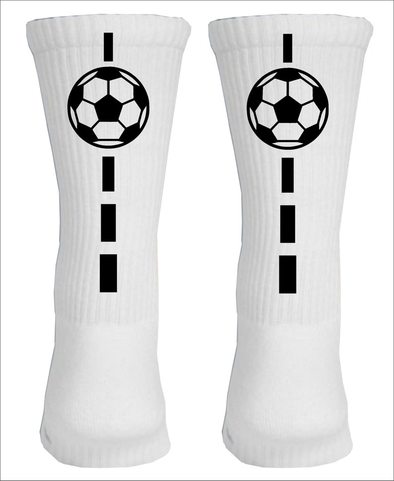 May include: Pair of white athletic socks with a black soccer ball and a dashed line design.