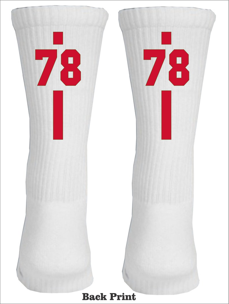 May include: A pair of white athletic socks with red numbers "78" and a red vertical line on each sock.