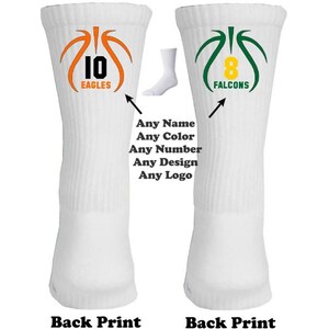 May include: Two white basketball socks with custom designs. The left sock has an orange basketball with the number 10 and the word "EAGLES". The right sock has a green basketball with the number 8 and the word "FALCONS".