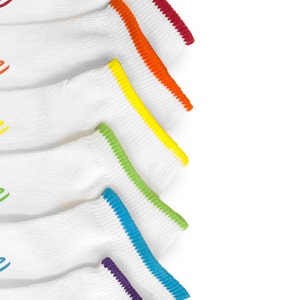 May include: Five pairs of white ankle socks with colorful trim. The trim colors are red, orange, yellow, green, and purple.