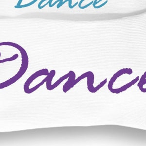 May include: White socks with the word "Dance" written in purple cursive lettering.