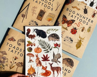 May include: Three sheets of temporary tattoos featuring woodland creatures, bugs, and forest school themes. The sheets are printed on brown paper with white text and illustrations. The tattoos include a badger, hedgehog, fox, campfire, and a variety of insects.