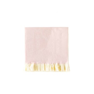 May include: A square, light pink paper napkin with a textured surface and a fringe of cream-colored tassels along the bottom edge. The napkin is set against a white background.