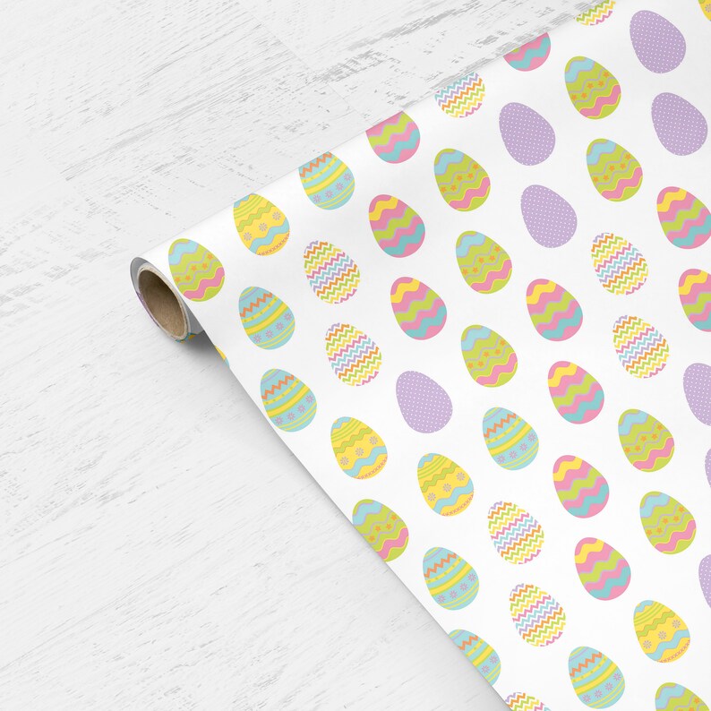 May include: White wrapping paper with a repeating pattern of colorful Easter eggs. The eggs are decorated with different patterns, including polka dots, stripes, and zigzags.