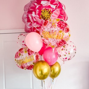 May include: A bouquet of pink, gold, and clear balloons with floral and confetti patterns. The balloons spell out "Happy Mother's Day!" and are tied together with pink ribbons. A large pink flower balloon is at the top of the bouquet.