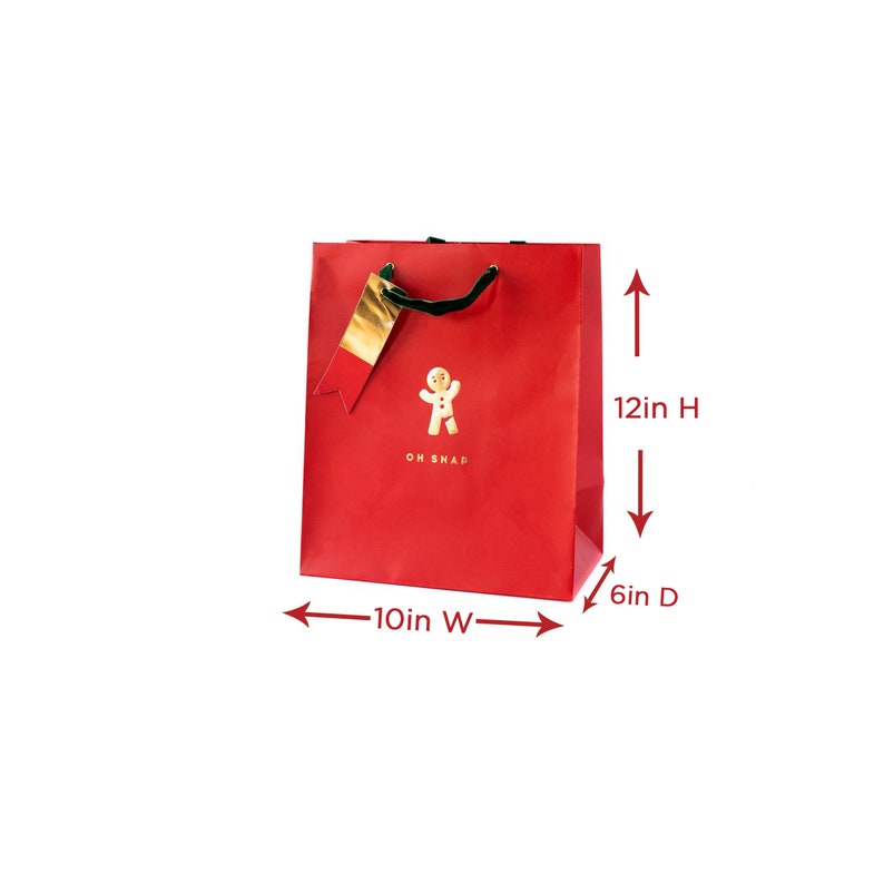 May include: Red gift bag featuring a gingerbread man graphic and the text "OH SNAP". The bag measures 30cm high, 25cm wide, and 15cm deep. It has a gold tag and a green handle.