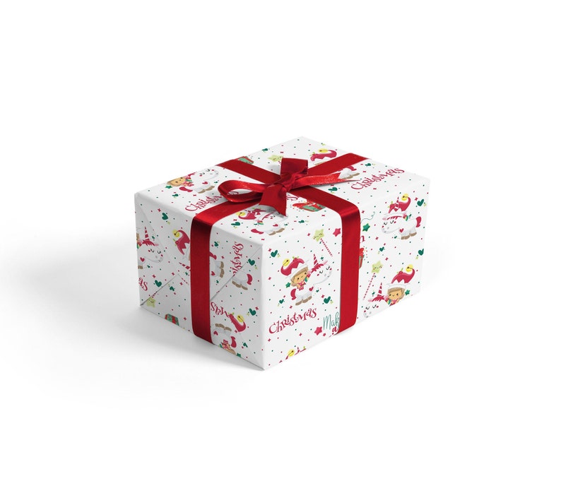 May include: A white gift box with a red ribbon and a Christmas themed wrapping paper featuring elves and unicorns. The wrapping paper has the text "Christmas Magic" printed on it.