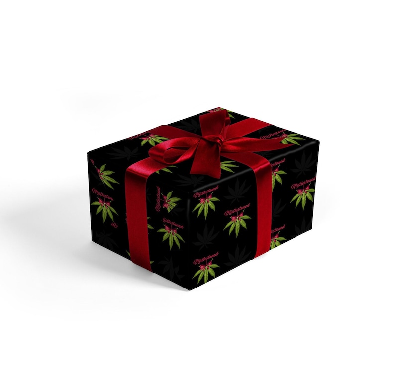 May include: A black gift box with a red ribbon and a repeating pattern of green marijuana leaves and the text "MisterGreen" in pink.