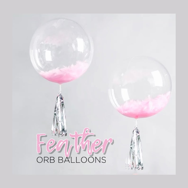 May include: Two clear orb balloons with pink feathers inside and silver streamers hanging from the bottom. The text "Feather Orb Balloons" is written below the balloons.