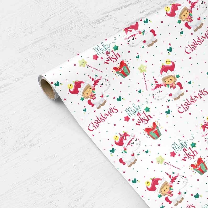 May include: White wrapping paper with a repeating pattern of a unicorn, a girl wearing a red elf hat, and the text "Make a wish" and "Christmas".