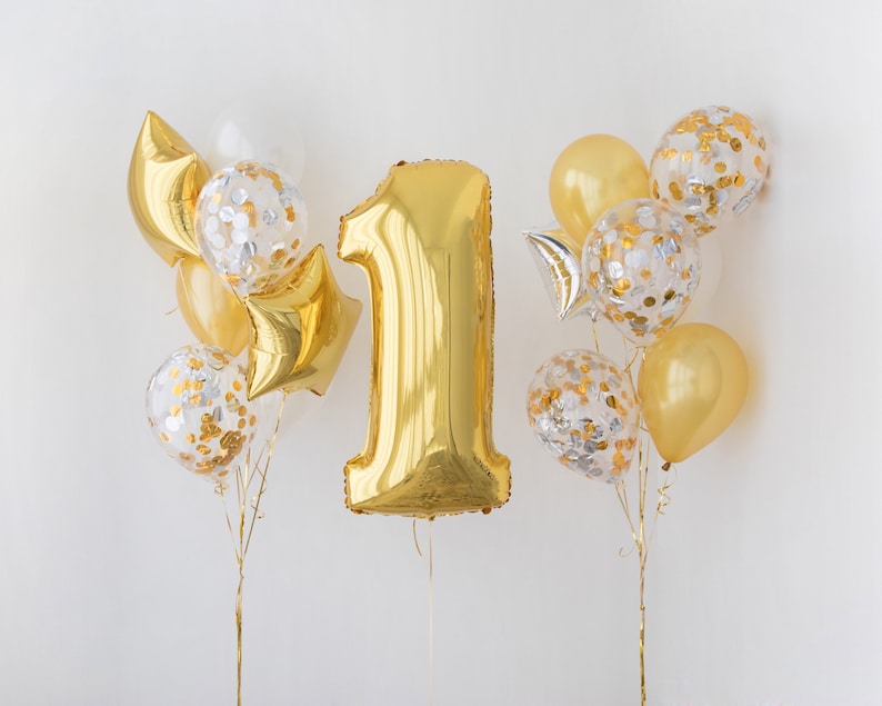 May include: Gold number one balloon with gold and silver confetti balloons.