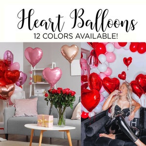 May include: A variety of heart-shaped balloons in pink, red, and gold. The balloons are arranged in a room with a couch and a bouquet of red roses. The text "Heart Balloons 12 Colors Available!" is displayed at the top of the image.