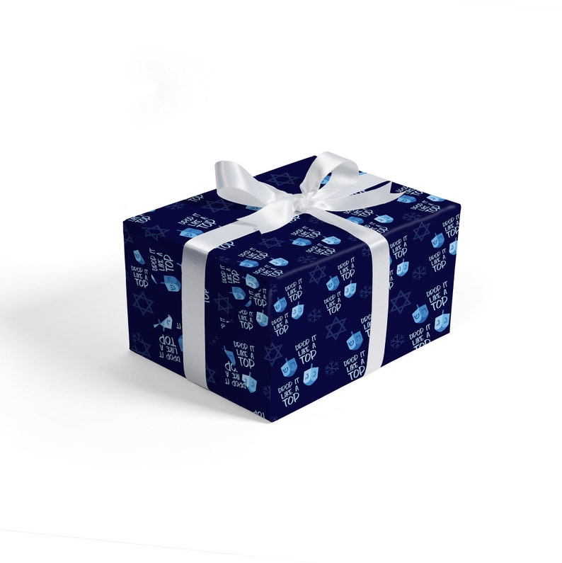 May include: A blue gift wrap with a white ribbon. The wrapping paper has a repeating pattern of blue dreidels and the text "Spin it like a top".