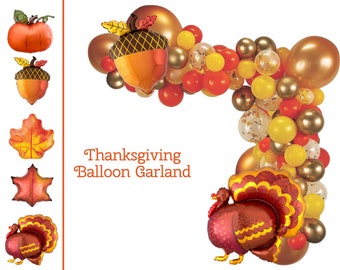 May include: Thanksgiving balloon garland with orange, yellow, and brown balloons in the shape of pumpkins, acorns, leaves, and a turkey. The garland is perfect for decorating for a Thanksgiving party.