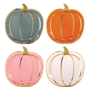May include: Four pumpkin-shaped paper plates in shades of blue, orange, pink, and white. Each plate has gold accents outlining the pumpkin shape and a gold rim. The plates are designed for a fall-themed party or event.
