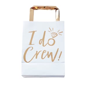 May include: White paper gift bag with gold handles and the text "I do Crew!" printed on the front. A gold diamond ring icon is above the text.