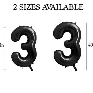 May include: Two black number 3 foil balloons, one 86 cm tall and the other 102 cm tall. The text "2 Sizes Available" is above the balloons. These balloons are suitable for birthday parties or other celebrations.