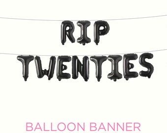 May include: Black balloon banner spelling "RIP TWENTIES" strung on a thin wire. The words are in capital letters. Below the banner, the text "BALLOON BANNER" is written in pink.