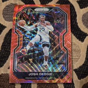 May include: A basketball trading card featuring Josh Okogie of the Minnesota Timberwolves. The card has a red and orange holographic design with the Prizm logo at the top. Okogie is shown in action, wearing a white and blue jersey.
