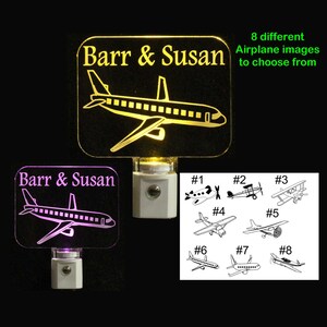 May include: A personalized night light with the names "Barr & Susan" and an airplane silhouette. The light is available in yellow or purple. Eight different airplane images are available to choose from.