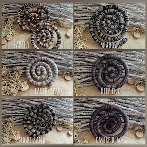May include: Six spiral-shaped decorative items in various color schemes, including earthy tones, black and gray, and ombre black. Each item has a unique name: "Earthy", "Shadows", "Earthy Sparkle", "Deep End", "Night Sand", and "Ombre Black".
